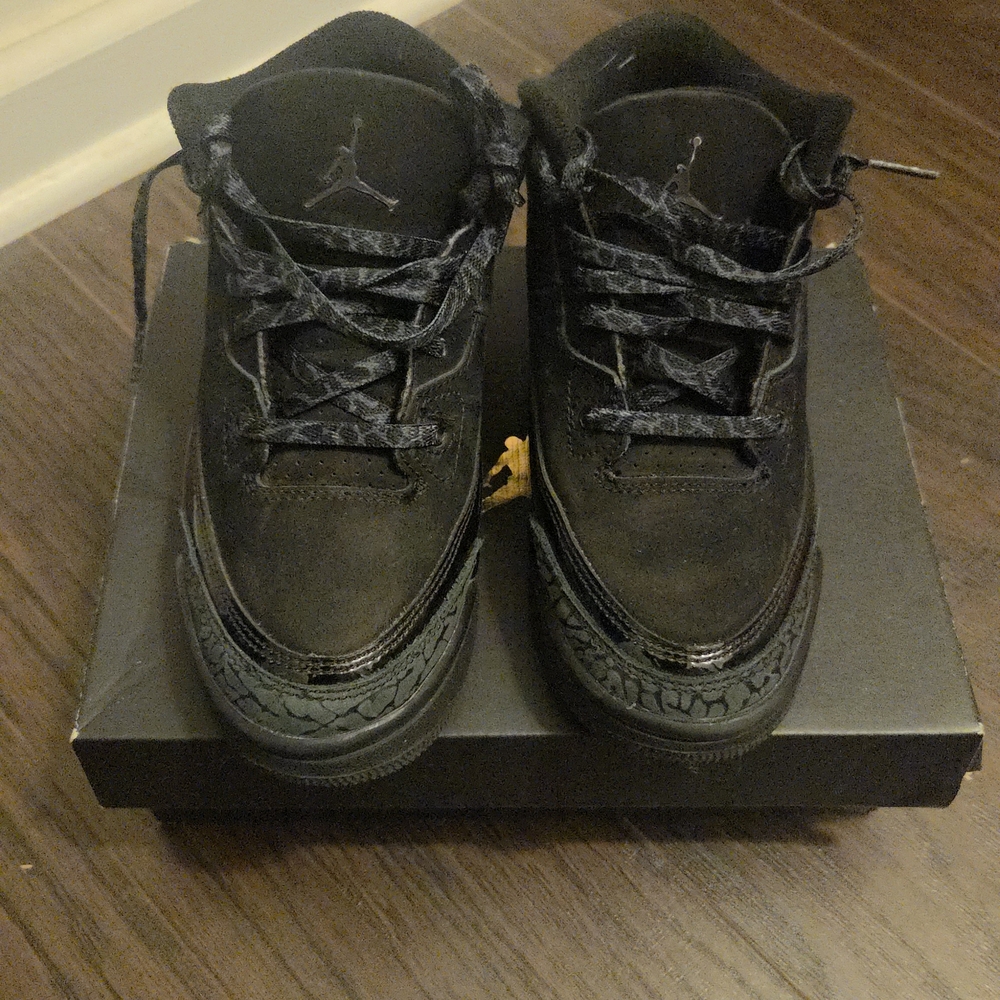 Kid's Air Jordan 3 Retro "Black Cat" sneakers. 